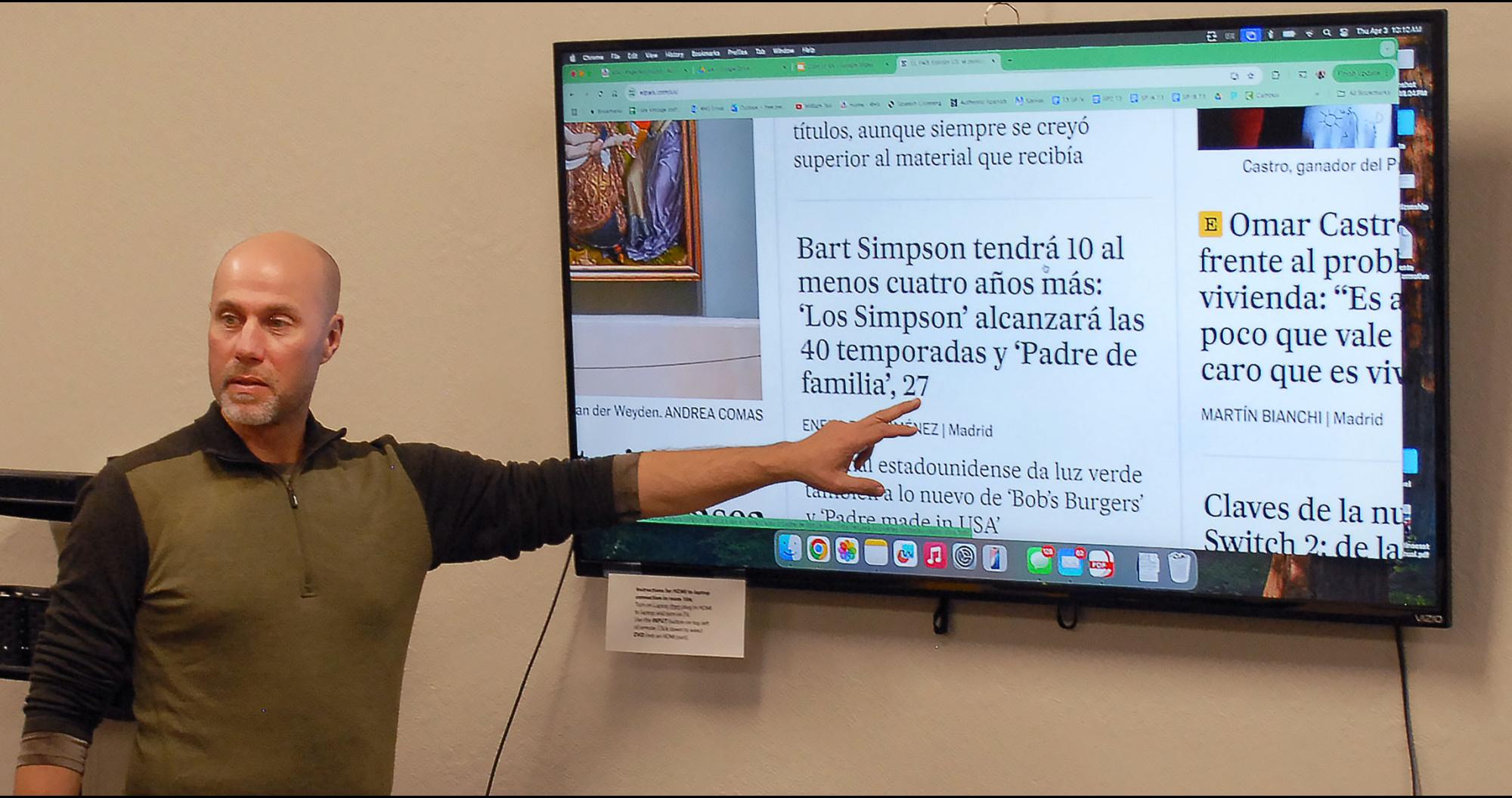 Spanish teacher leads class discussion of headlines.